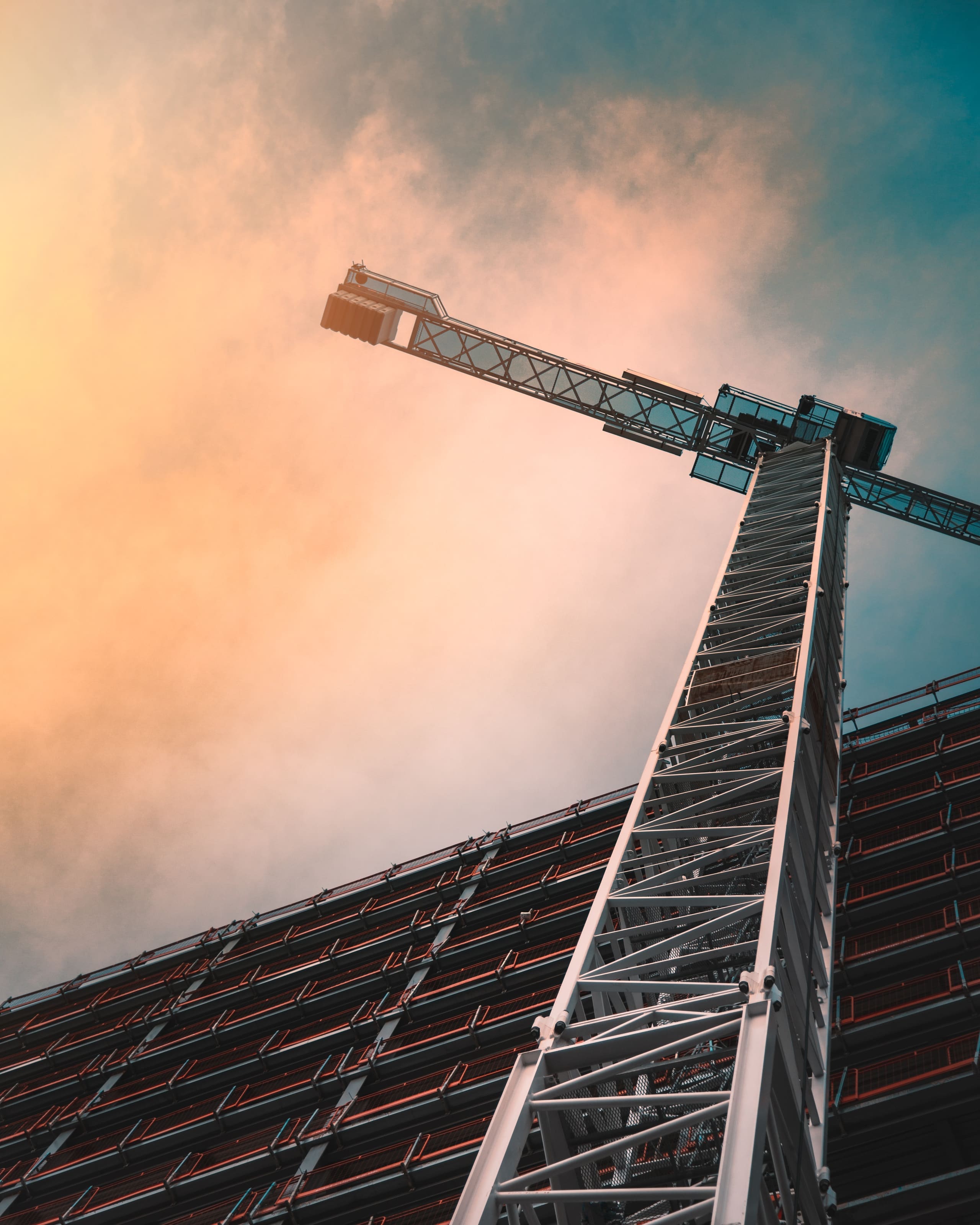 Tower crane above a building site at dusk